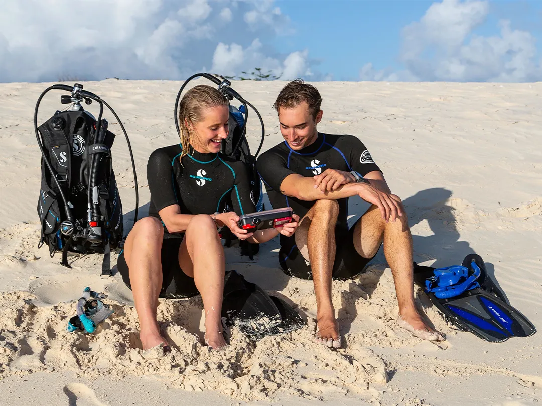 Charter superyacht guests on beach wearing SCUBAPRO gear