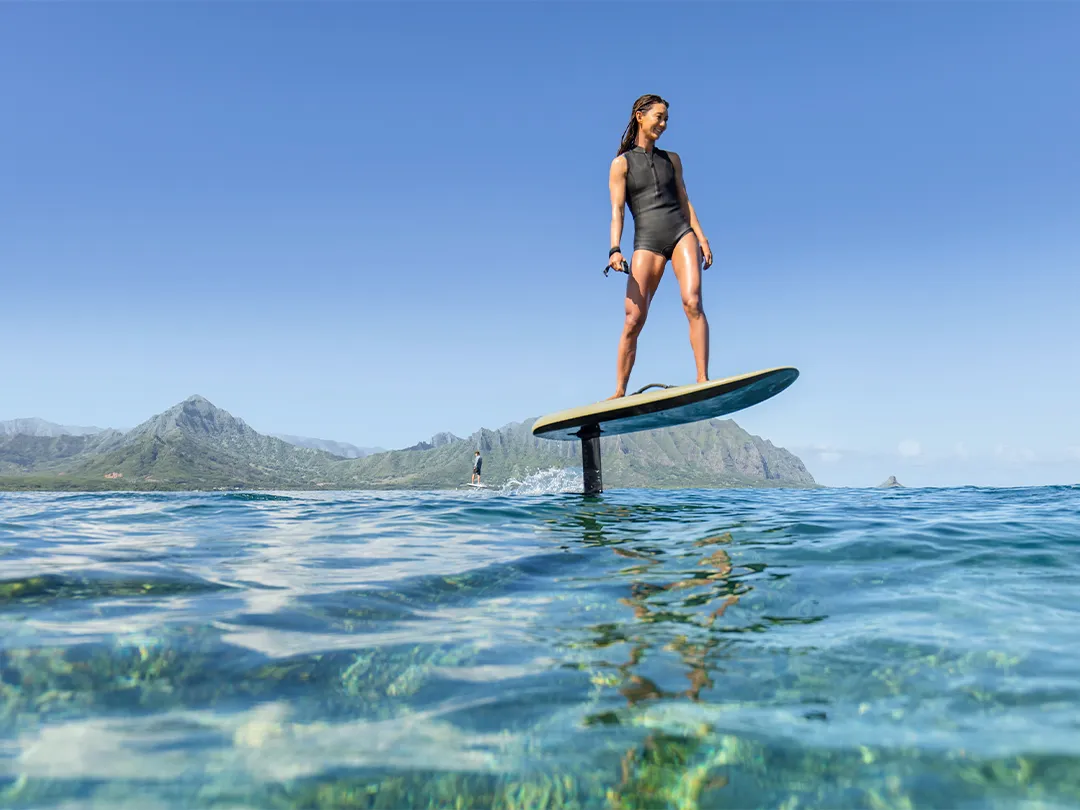 Member of charter yacht crew riding a Fliteboard