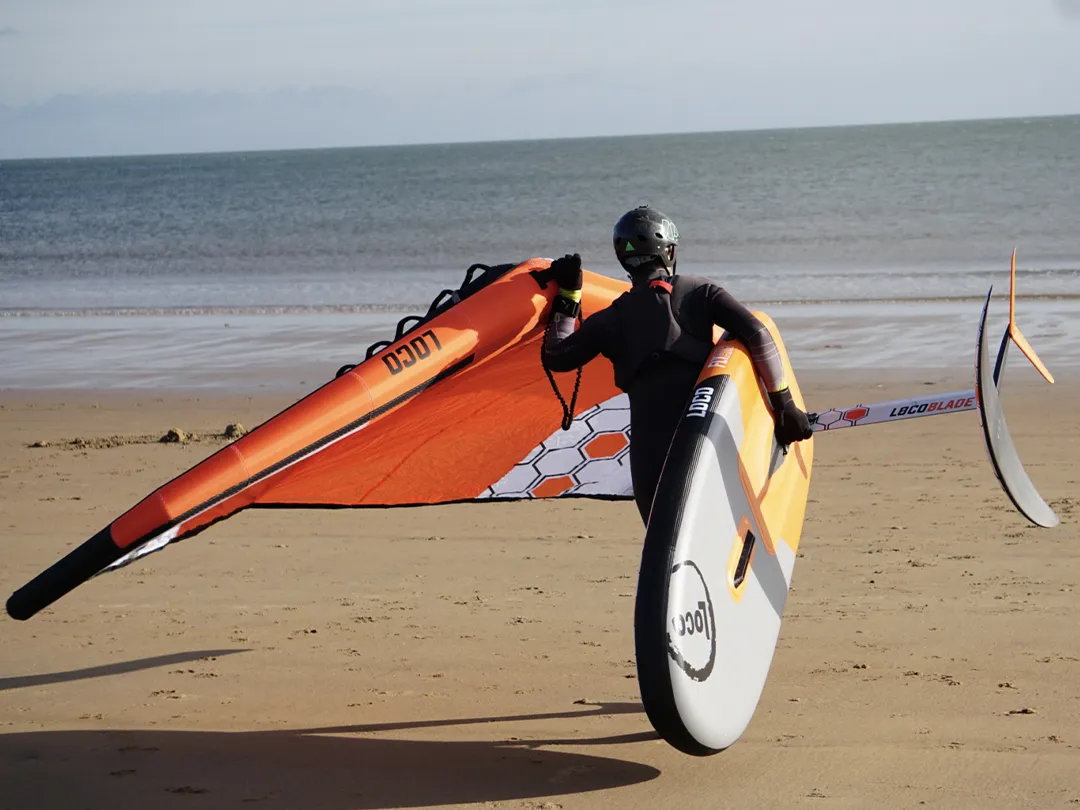 MoreFun Loco Surfing rider taking Wing Foil out to the ocean
