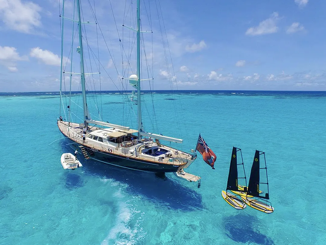 Tiwal Dinghies moored behind a luxury yacht